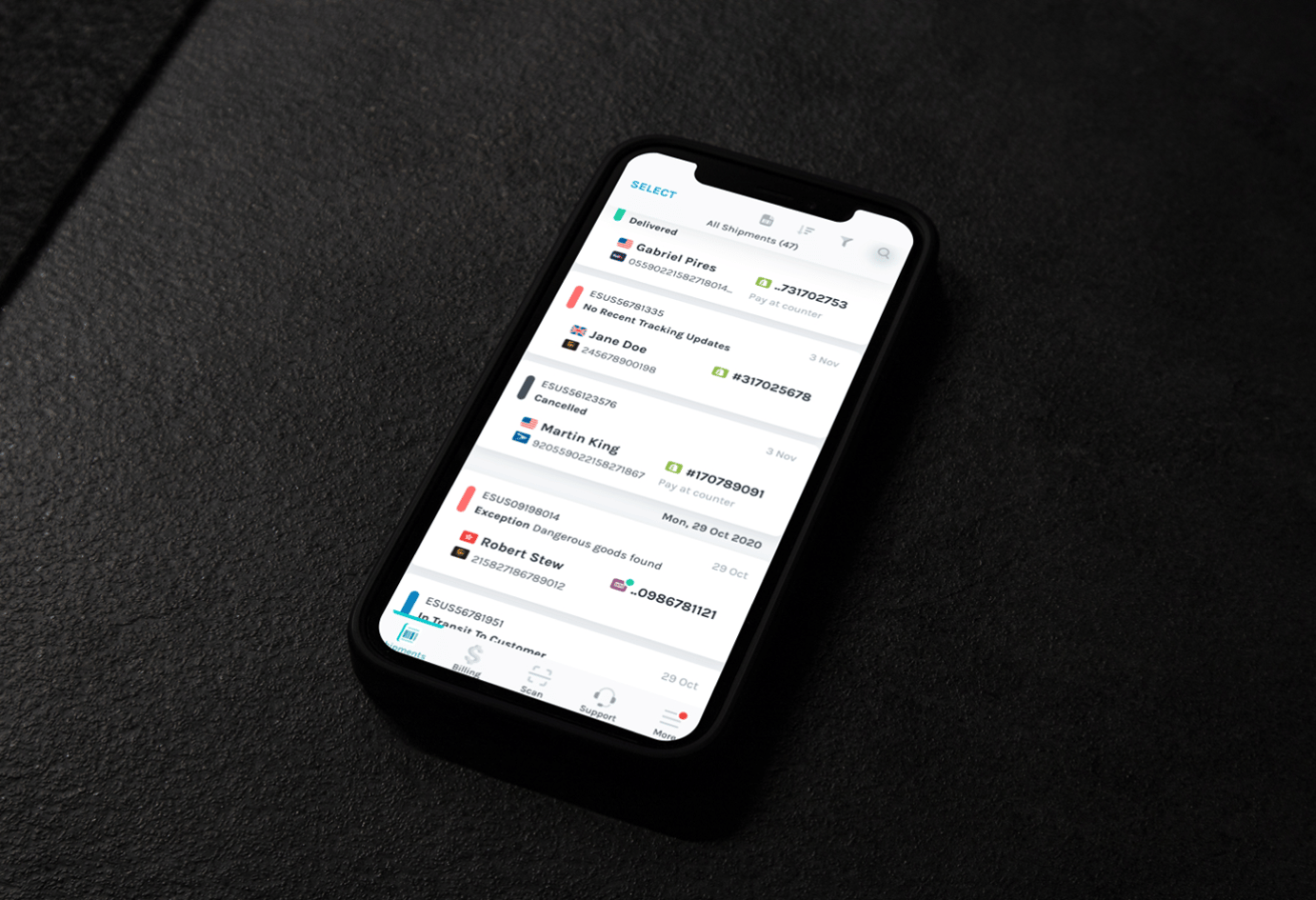 Picture of smartphone on a dark desk with a bright screen that has the Easyship mobile application's package tracking screen on it.